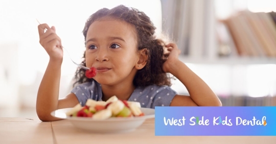 little girl eating fruit